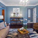 As seen on HGTV's Renovation Raiders, the Rangel's living room has been transformed into a media free oasis, which has a contemporary look with a rustic feel. There is no longer hand me down furniture, and the space has personal touches to make this now their home. The deep blue walls envoke relaxation, there are plenty of cozy elements and seating for all, even a built in ledge under the window for the cat to sit and look outside.The space is truely welcoming to entertain family and friends. The wall has been opened up to expose the staircase which opens up the room and it flows into the dining room. (after), ( After 4 )